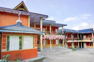 a group of buildings with red and orange at Hotel O Rudang Rudang Sibayak in Berastagi