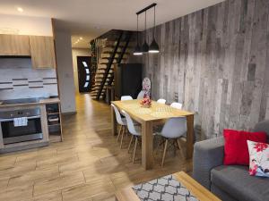 a kitchen and dining room with a table and chairs at Apartament KAOLA in Jelenia Góra