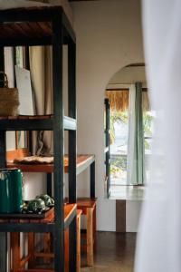 a room with a window and a table and shelves at Casa De Amor Lambug in Badian