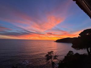 a sunset over a body of water at Unparalleled sea view in Tossa de Mar