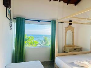 Ένα ή περισσότερα κρεβάτια σε δωμάτιο στο Harmony inn - Tangalle