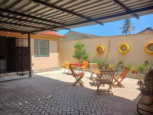 a patio with a table and chairs on a patio at Serenity in Disguise in Mombasa