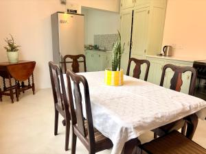 a kitchen with a table with a white table cloth at Sunrise & Sunset Haven in Mossel Bay