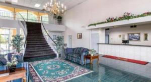 a living room with a couch and a staircase at Econo Lodge Dalton West in Dalton +58 photos