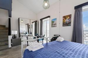 a bedroom with a blue bed with towels on it at Hotel Britannia in Genova