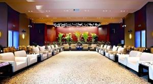a large banquet hall with white chairs and a stage at Quanzhou Guest House Hotel in Quanzhou +207 photos