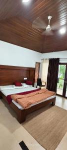 a bedroom with two beds and a chair in it at BharathaPuzha Resort in Kārakkād +11 photos