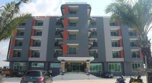 a large building with cars parked in front of it at PJ PLACE in Ban Bang Samak