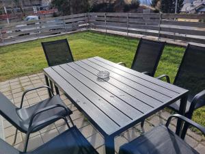 a picnic table with chairs and a engagement ring on it at Sanbe Garden by Quokka 360 - flat with garden in San Bernardino in Mesocco +27 photos