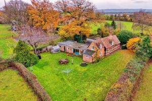 an aerial view of an old house in a field at Finest Retreats - Cricketers Cottage in Alderley