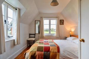 a bedroom with a bed and a window at Finest Retreats - Cricketers Cottage in Alderley