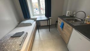 a small room with a bed and a sink at StarBal in Radom