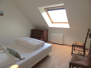 een slaapkamer met een bed, een ladekast en een raam bij Agapanthe blanche in La Garde