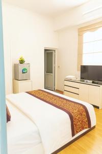 Ένα ή περισσότερα κρεβάτια σε δωμάτιο στο K-BOSS Hotel