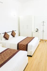 Ένα ή περισσότερα κρεβάτια σε δωμάτιο στο K-BOSS Hotel