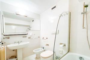 a bathroom with a sink and a toilet and a shower at Hotel Britannia in Genova +32 photos
