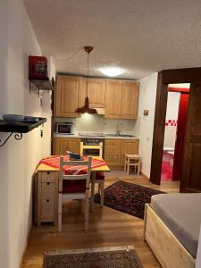 a kitchen with a table and a table and chairs at Casa Lilly in Folgarida