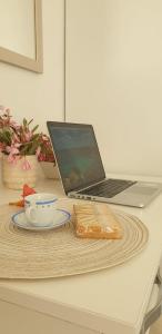 a laptop computer sitting on a table with a plate at Lampedusa Centro Camere&Appartamenti in LMP