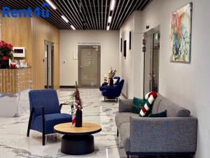 eine Lobby mit 2 Sofas, einem Tisch und Stühlen in der Unterkunft Apartamenty Nad Zatoką in Olsztyn