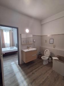 a bathroom with a sink and a toilet and a bed at FASTHOTEL Le Costabonne in Prats-de-Mollo-la-Preste