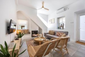 a living room with a couch and a fireplace at Casa Ladeira in Loulé