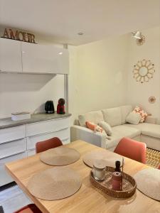 a living room with a table and a couch at Appartement 3 chambres - 8 couchages in Six-Fours-les-Plages