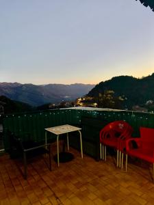 a table and chairs on a balcony with a view at Maison de village in Zevaco
