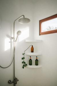 a bathroom with a lamp and a shelf at Casa De Amor Lambug in Badian