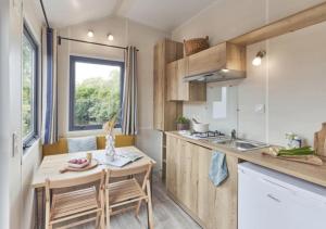 a small kitchen with a table and a sink at Weekend Glamping Resort in San Felice del Benaco +34 photos