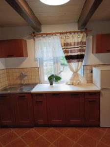 a kitchen counter with a sink and a window at Dom w górach Zacisze lasu in Sucha Beskidzka +2 photos