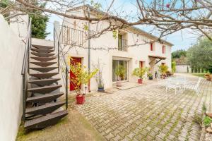 a house with a staircase leading to a patio at Chambre Bleuet in Piolenc +18 photos