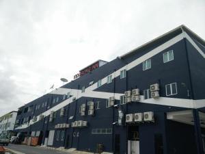 a large blue building with balconies on the side of it at Kidurong Inn in Bintulu