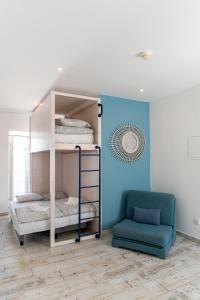 a room with two bunk beds and a chair at WOT Peniche Social in Peniche