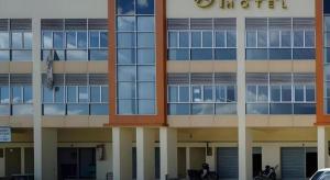 a building with a car parked in front of it at TT Dorf Hotel (Taiping) in Taiping
