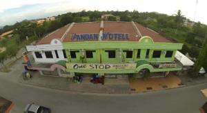 a building with a sign on the side of it at OYO 90785 Pandan Hotel in Buang Sayan