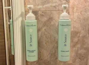 two bottles of soap sitting on a wall at Jubilee Prestige Hotel Ratchadapisek in Bangkok +62 photos