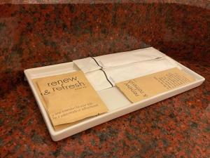 a white plate with a book on top of it at Jubilee Prestige Hotel Ratchadapisek in Bangkok