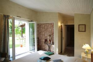 a bedroom with a bed and a sliding glass door at Marievalerianne in Mirefleurs