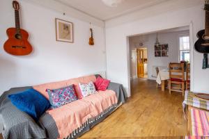 a living room with a couch and a guitar at Exesixteen in Exeter
