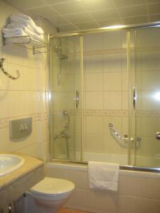 a bathroom with a shower and a toilet and a sink at Candan Beach Hotel in Marmaris