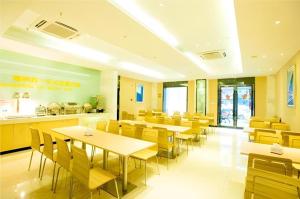 a dining room with tables and chairs in a restaurant at City Comfort Inn Wuhan Jianghan Road Jiali Square in Wuhan