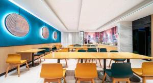 a dining room with tables and chairs and blue walls at City Comfort Inn Wuhan Jianghan Road Jiali Square in Wuhan +182 photos