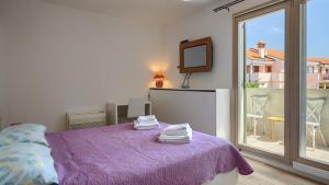 a bedroom with a purple bed and a balcony at Rustic villa Inga with pool and grill in Buje in Kaštel +31 photos