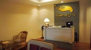 a living room with a table and chairs and a lamp at The Regent Ubon in Ban Na Khwai