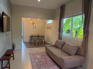 a living room with a couch and a table at Pool Villa Mango 2BR in Koh Phangan