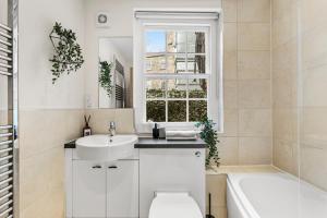a bathroom with a sink toilet and a window at Stylish Roman Bath Duplex - The Bridgeton in Bath