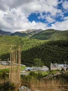 a view of a valley with mountains in the background at Siguniang Mountain Lanxi Wild Luxury Hotel in Mount Siguniang
