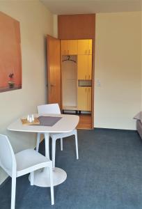 Zimmer mit einem Tisch und 2 Stühlen sowie einer Küche in der Unterkunft home31 in Hemmingen