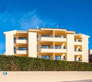 a building with a hedge in front of it at MallorcaRooms Cala Millor in Cala Millor