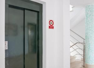 a elevator with a sign on the side of a wall at MallorcaRooms Cala Millor in Cala Millor